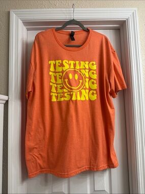 Orange Graphic Tee with Yellow Smiley 'TESTING' Print